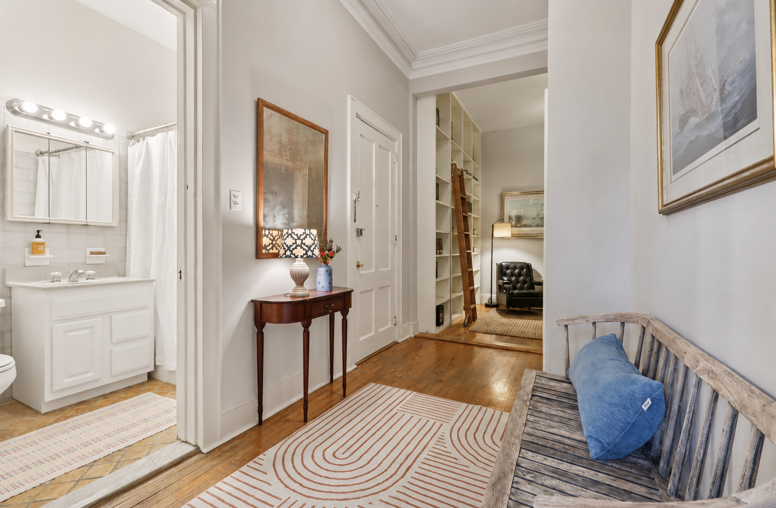 Staged entryway with console table and layered rug