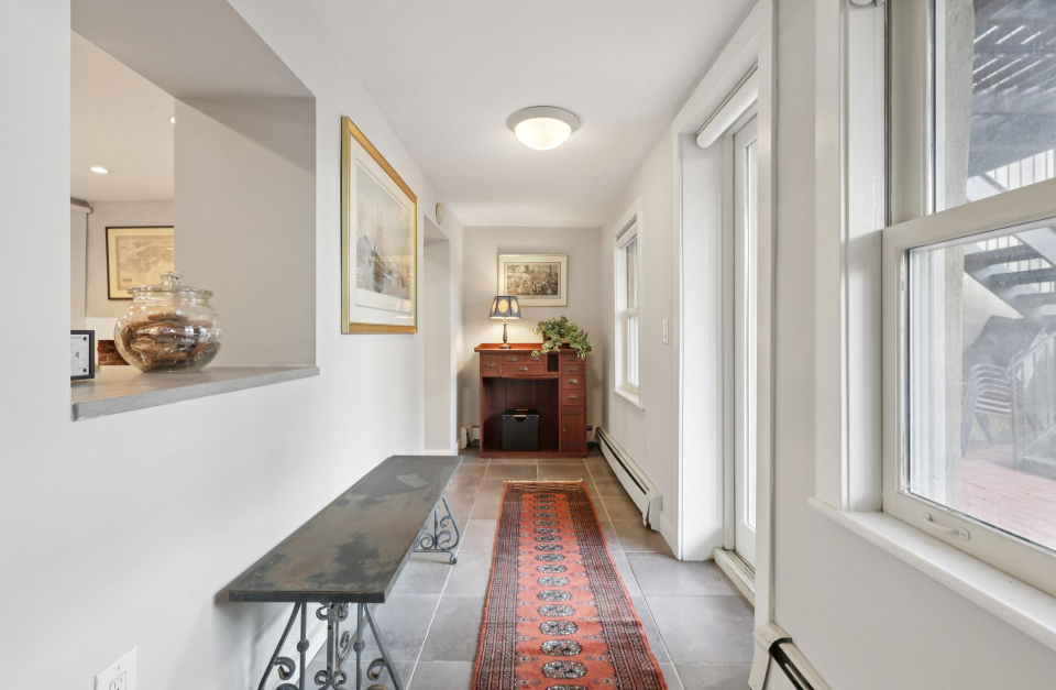 Staged hallway with bench, runner, and accent decor
